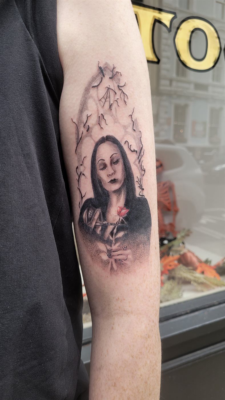 MORTICIA tattoo — black & grey, upper arm — by Kayleigh Chaos, tattoo artist in Perth, Scotland
