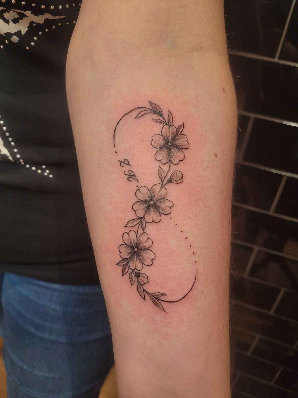 FLOWERS tattoo — black & grey, arm — by Kayleigh Chaos, tattoo artist in Perth, Scotland