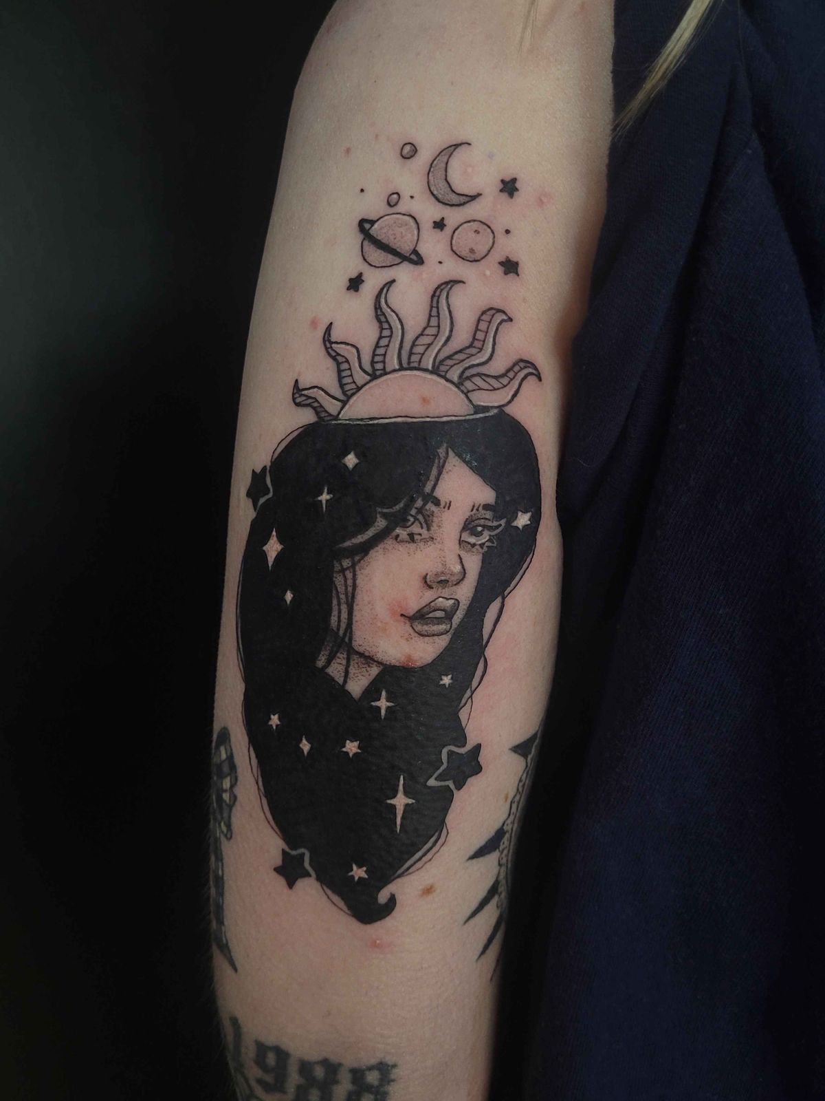 CELESTE tattoo — blackwork, upper arm — by Kayleigh Chaos, tattoo artist in Perth, Scotland
