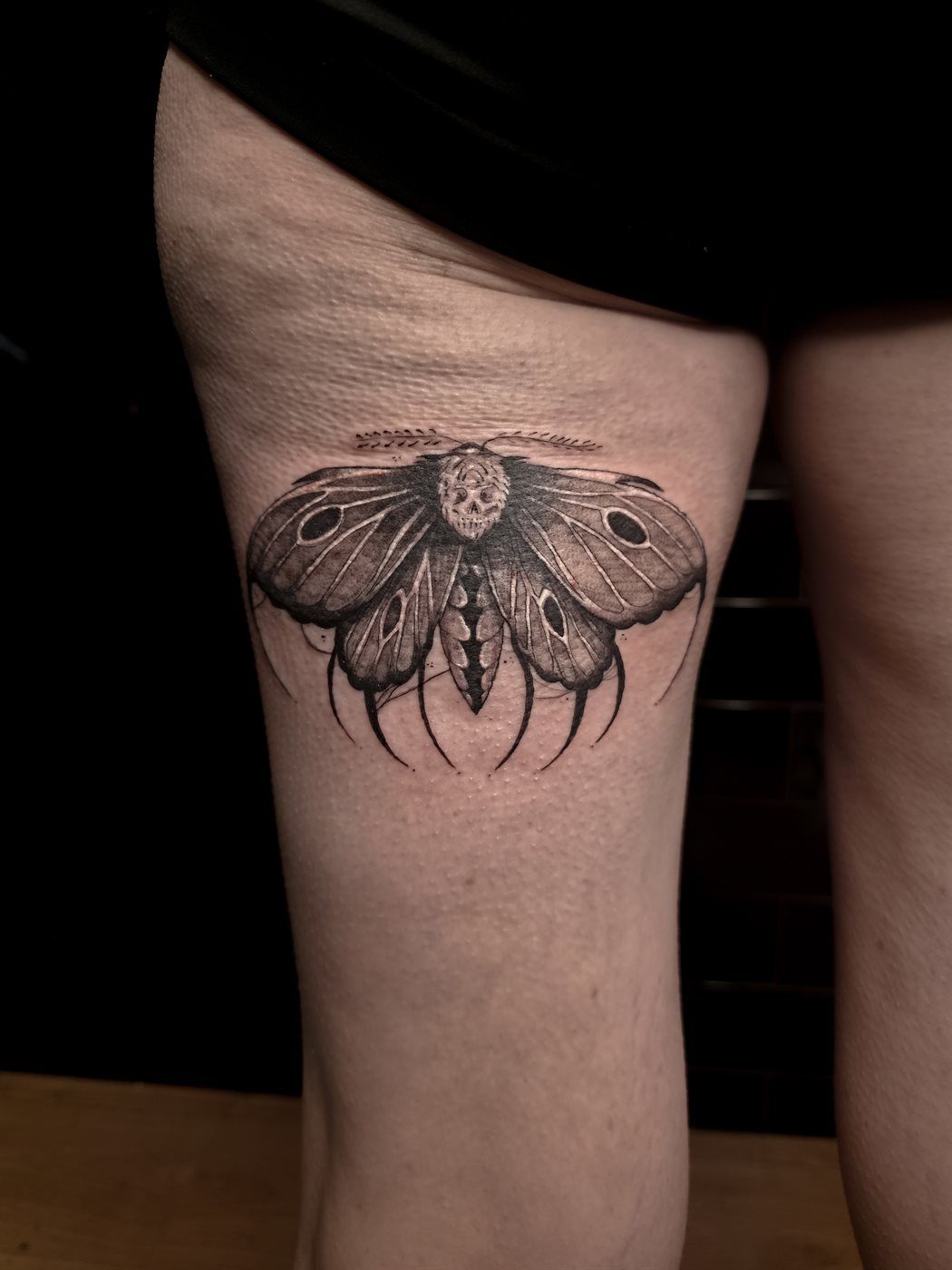 DEATH MOTH tattoo — blackwork, thigh — by Kayleigh Chaos, tattoo artist in Perth, Scotland