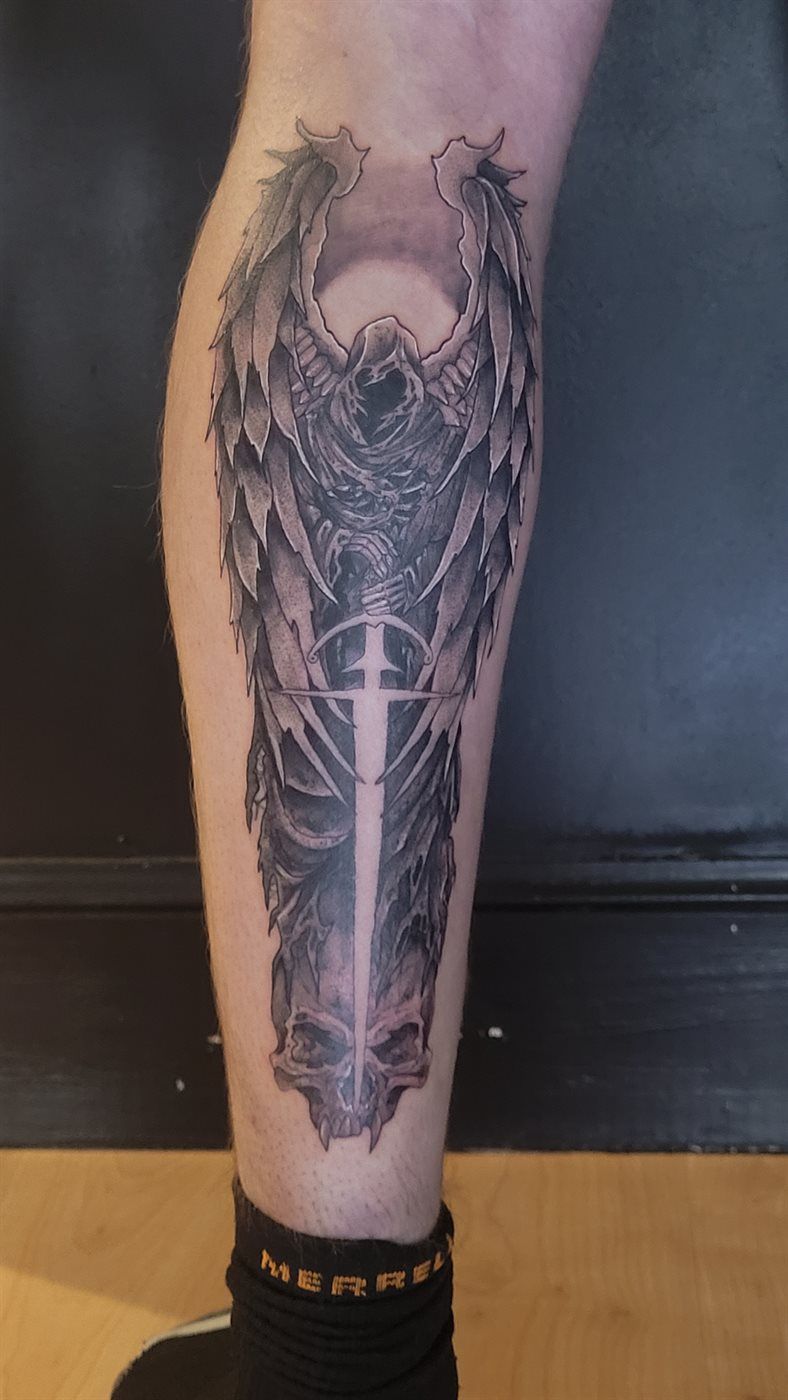 WINGED SWORD tattoo — blackwork, calf — by Kayleigh Chaos, tattoo artist in Perth, Scotland