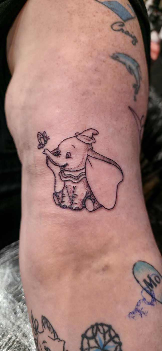 DUMBO tattoo — cartoon, upper arm — by Kayleigh Chaos, tattoo artist in Perth, Scotland