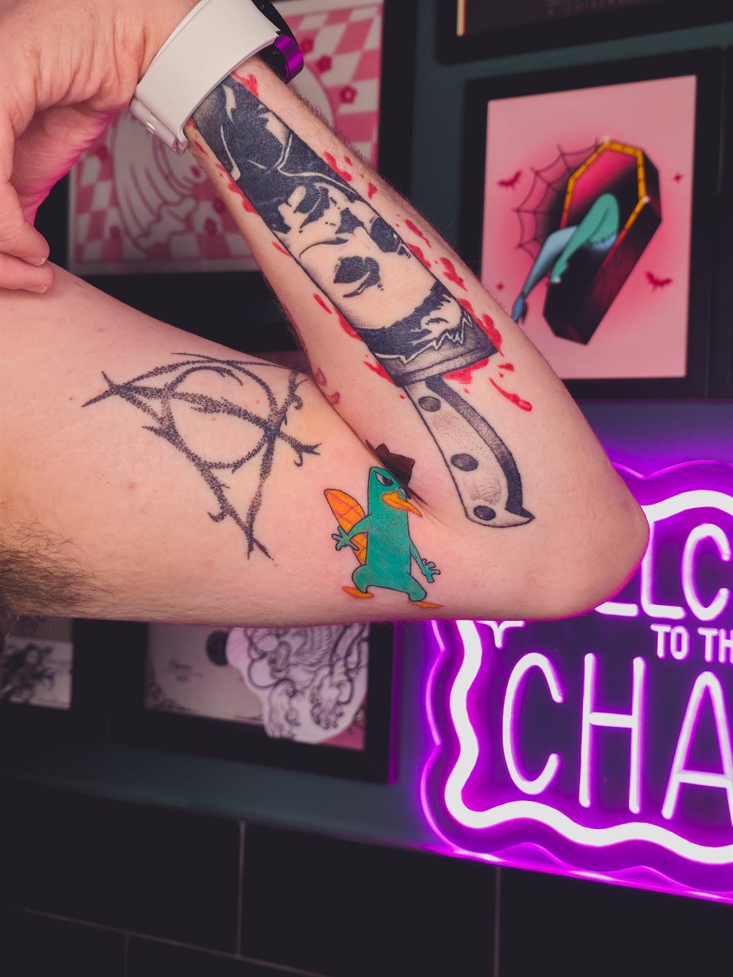 PERRY THE PLATYPUS tattoo — cartoon, elbow — by Kayleigh Chaos, tattoo artist in Perth, Scotland