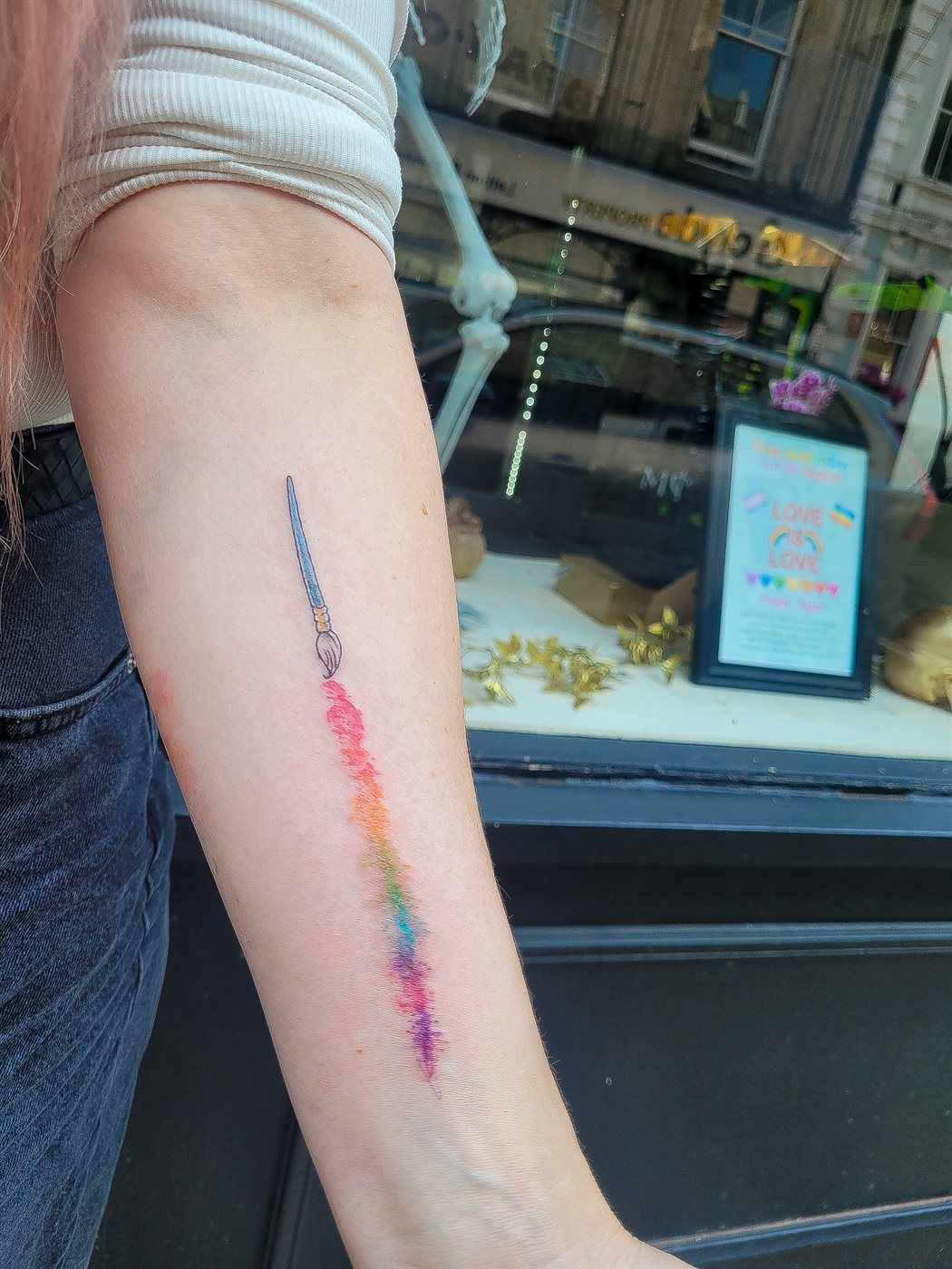 PAINTBRUSH RAINBOW tattoo — colour, forearm — by Kayleigh Chaos, tattoo artist in Perth, Scotland