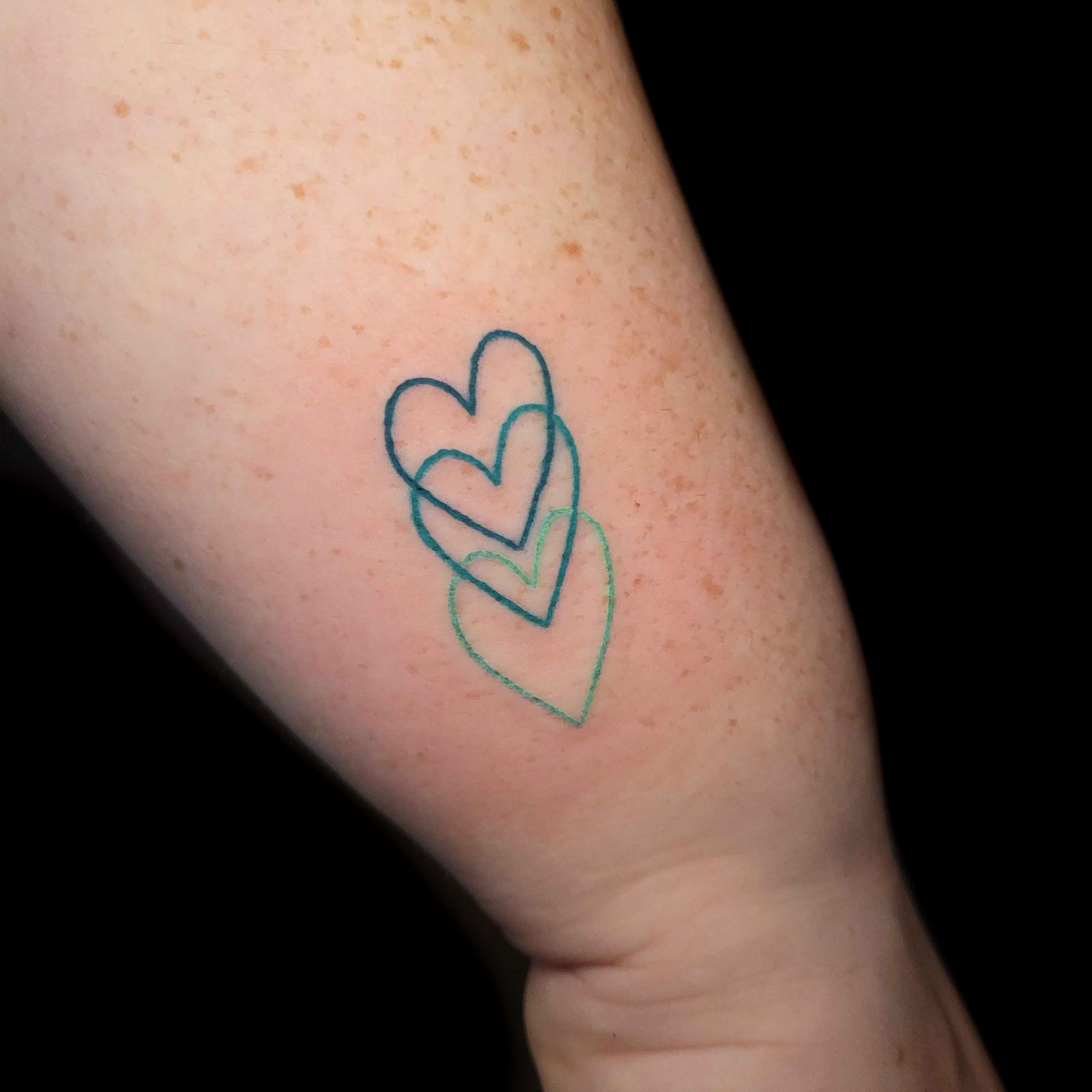 3 HEARTS tattoo — fine line, arm — by Kayleigh Chaos, tattoo artist in Perth, Scotland