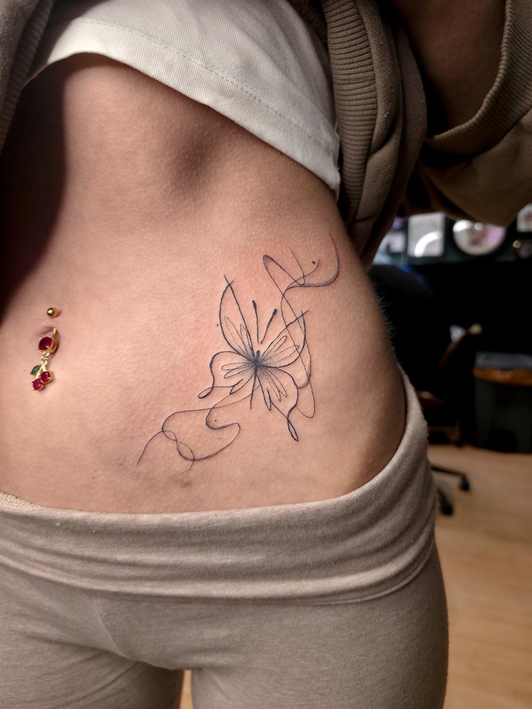 LILY tattoo — fine line, belly — by Kayleigh Chaos, tattoo artist in Perth, Scotland
