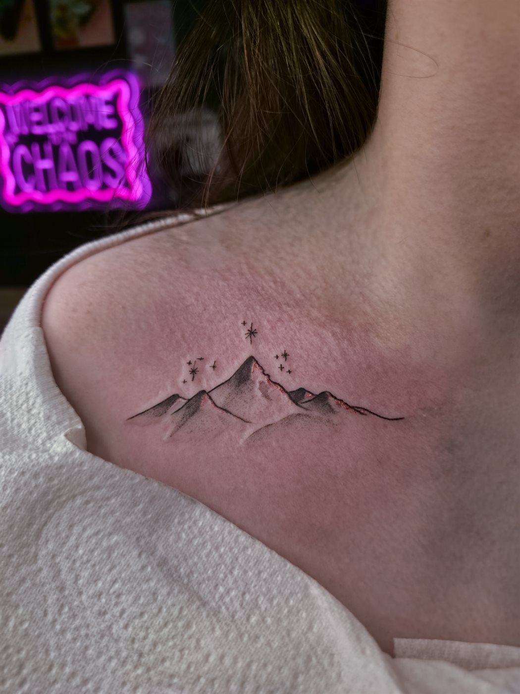 MOUNTAINS tattoo — fine line, collarbone — by Kayleigh Chaos, tattoo artist in Perth, Scotland
