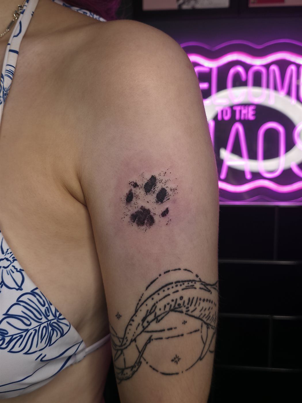 PAW PRINT tattoo — fine line, shoulder — by Kayleigh Chaos, tattoo artist in Perth, Scotland