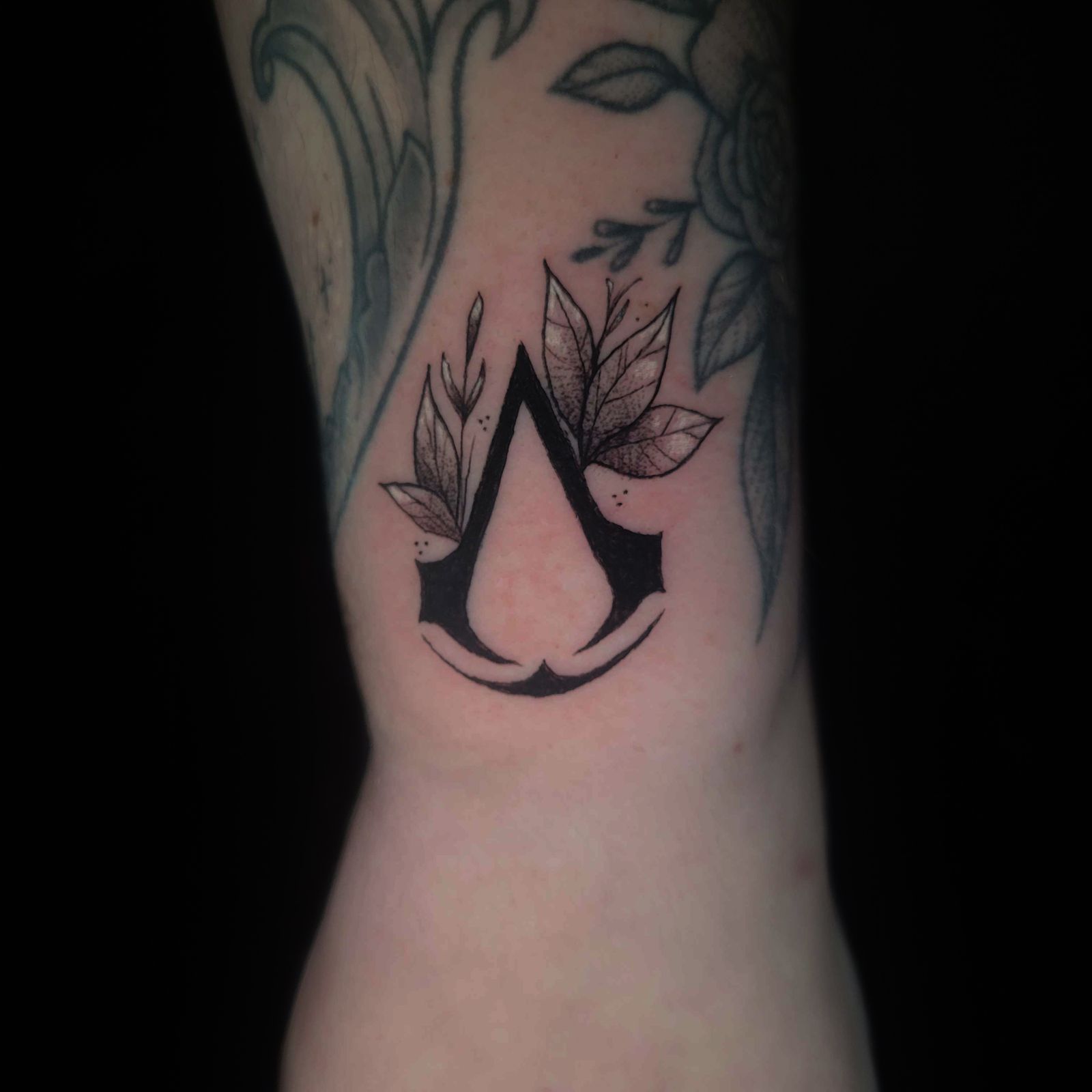 ASSASSINS CREED tattoo — gaming, wrist — by Kayleigh Chaos, tattoo artist in Perth, Scotland