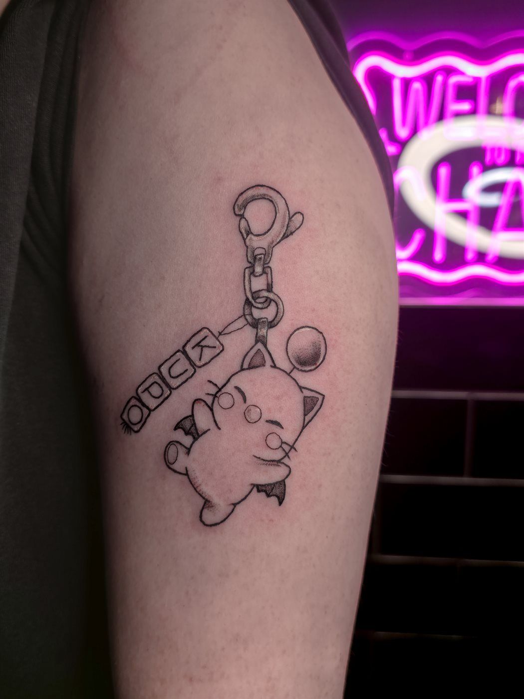 MOOGLE KEYCHAIN tattoo — gaming, upper arm — by Kayleigh Chaos, tattoo artist in Perth, Scotland