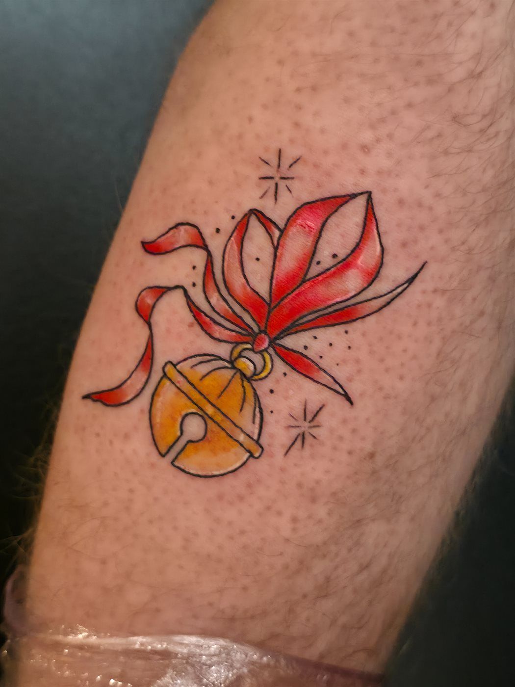 JINGLE BELL tattoo — kawaii, upper arm — by Kayleigh Chaos, tattoo artist in Perth, Scotland