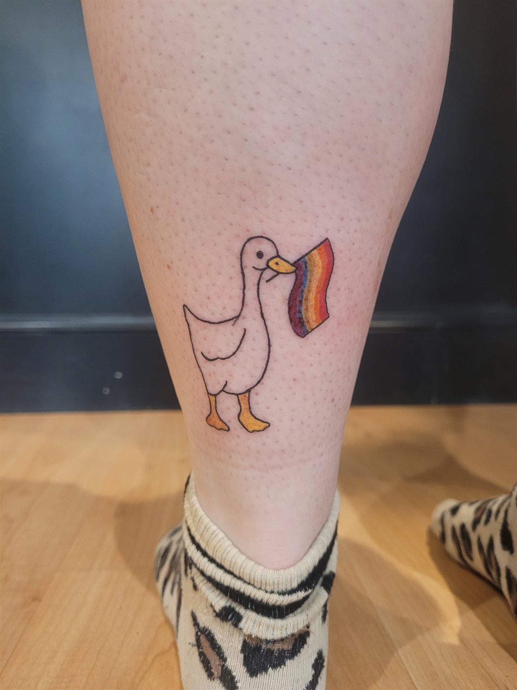 PRIDE GOOSE tattoo — kawaii, calf — by Kayleigh Chaos, tattoo artist in Perth, Scotland