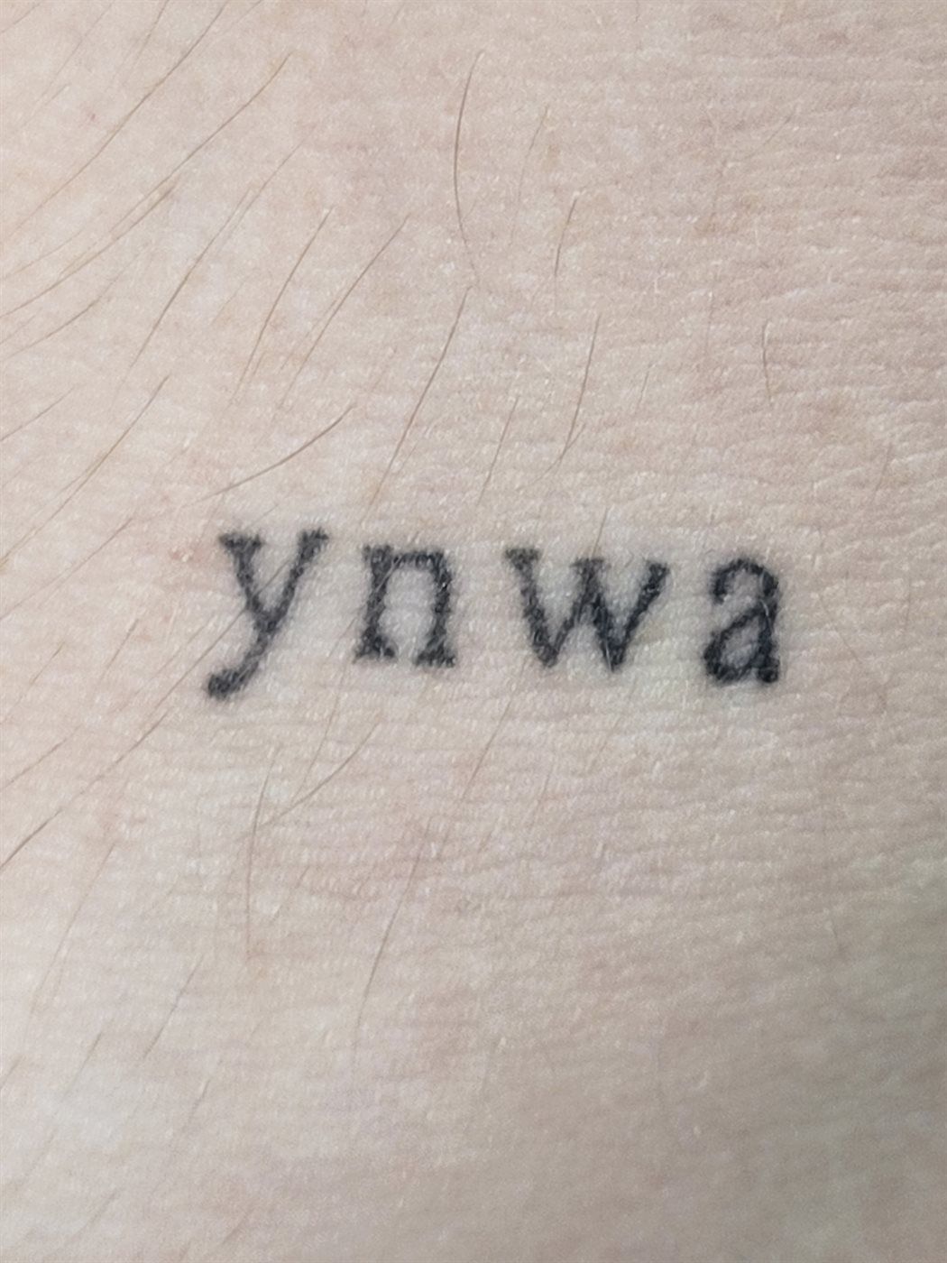 YNWA tattoo — script, arm — by Kayleigh Chaos, tattoo artist in Perth, Scotland