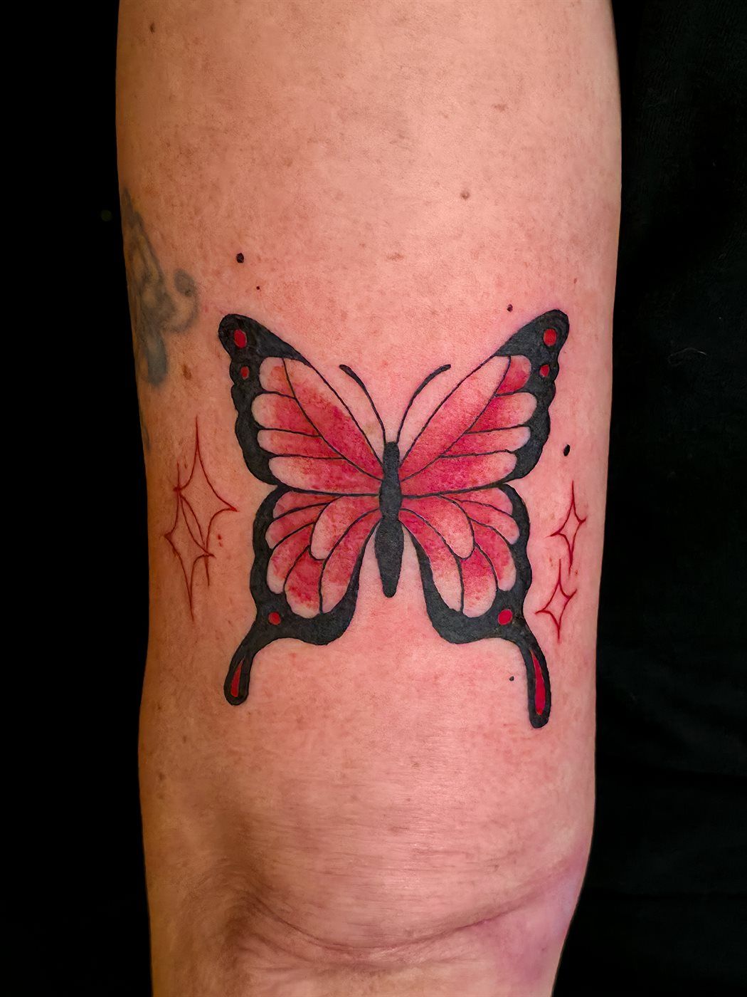 BUTTERFLY tattoo — trad, upper arm — by Kayleigh Chaos, tattoo artist in Perth, Scotland