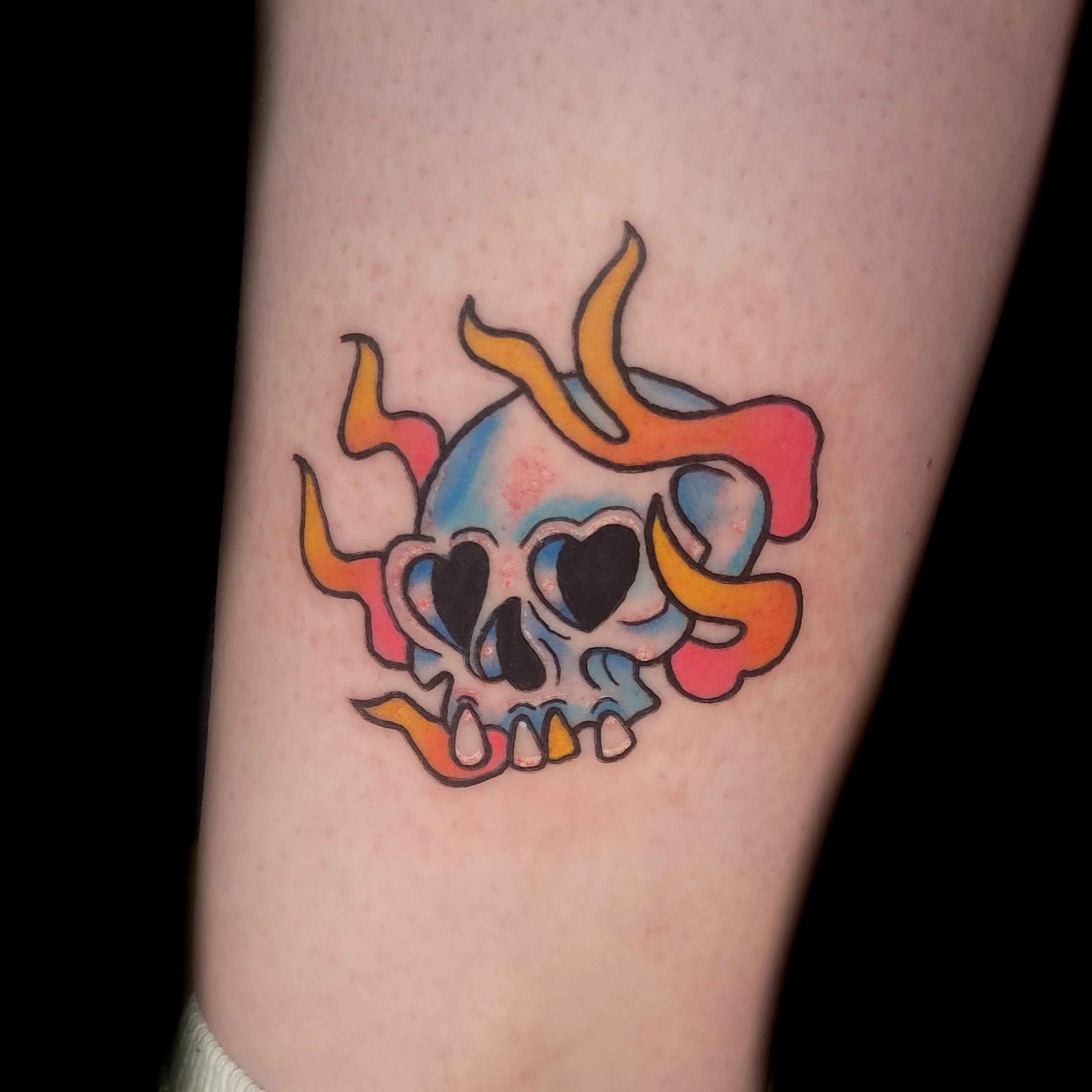 FLAMING SKULL tattoo — trad, leg — by Kayleigh Chaos, tattoo artist in Perth, Scotland